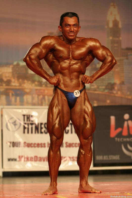 Very brawny guy bodybuilder posing. Beautiful sporty guy male power.  Fitness muscled man. Stock Photo | Adobe Stock