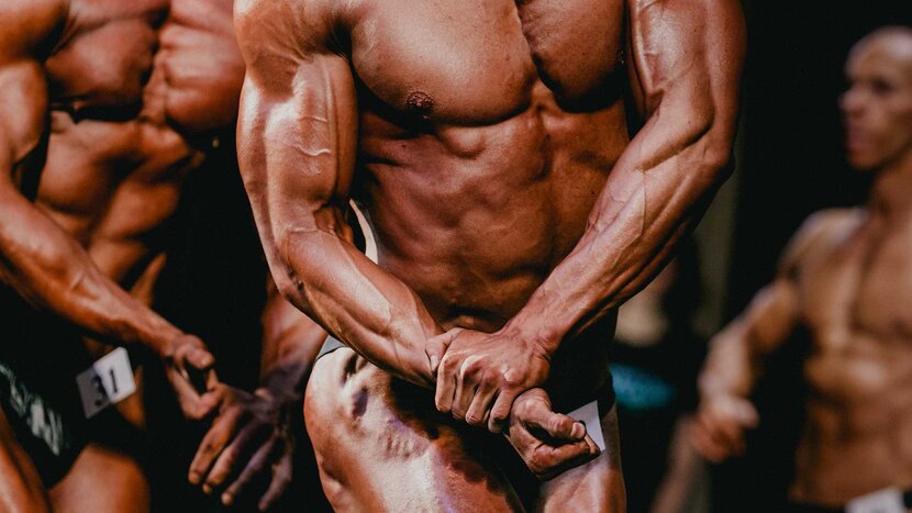 Mens Physique Posing During A Bodybuilding Competition Stock Photo - Alamy